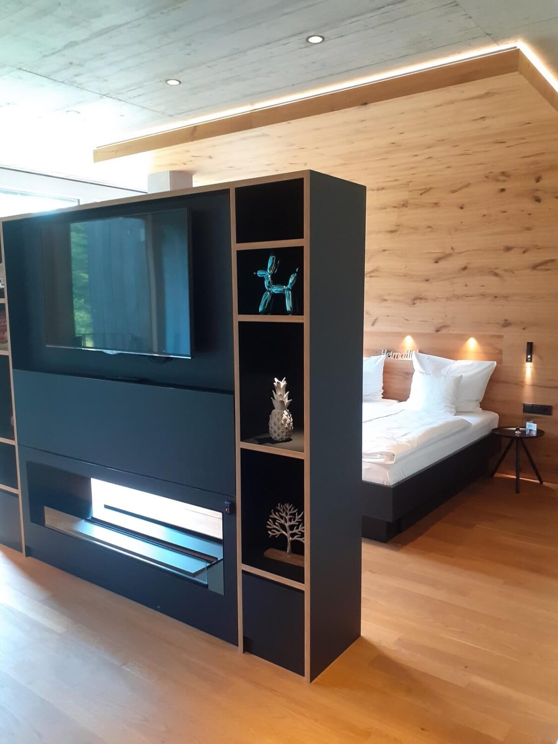 43 Ideas To Divide a Studio Apartment Into Multiple Rooms 31 studio-apartment-room-divider-bookcase-center-of-room-television-fireplace-nordroom