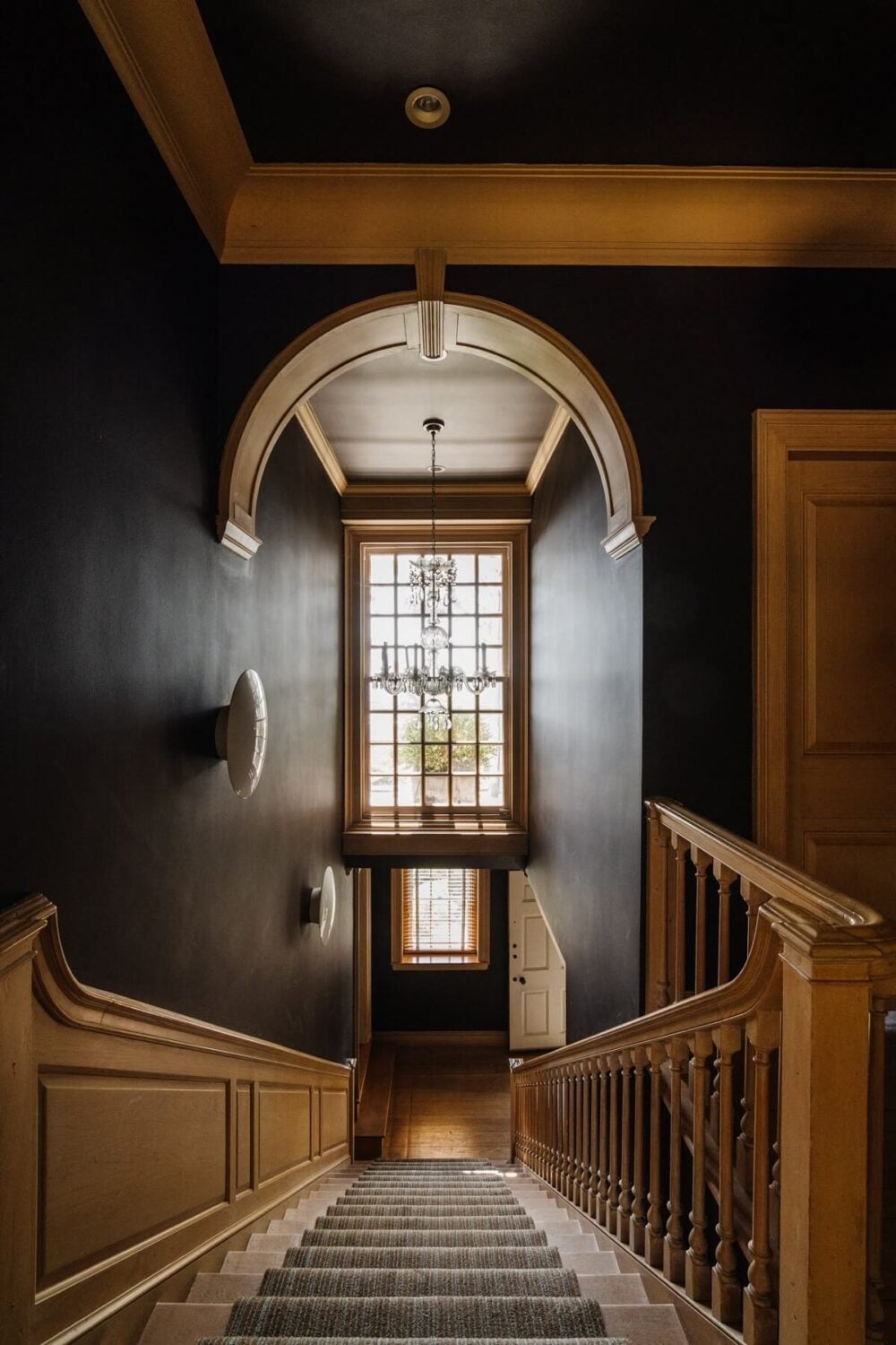 Black Accents in a Traditional Los Angeles Home 18 wooden-staircase-black-walls-arch-stained-glass-window-nordroom