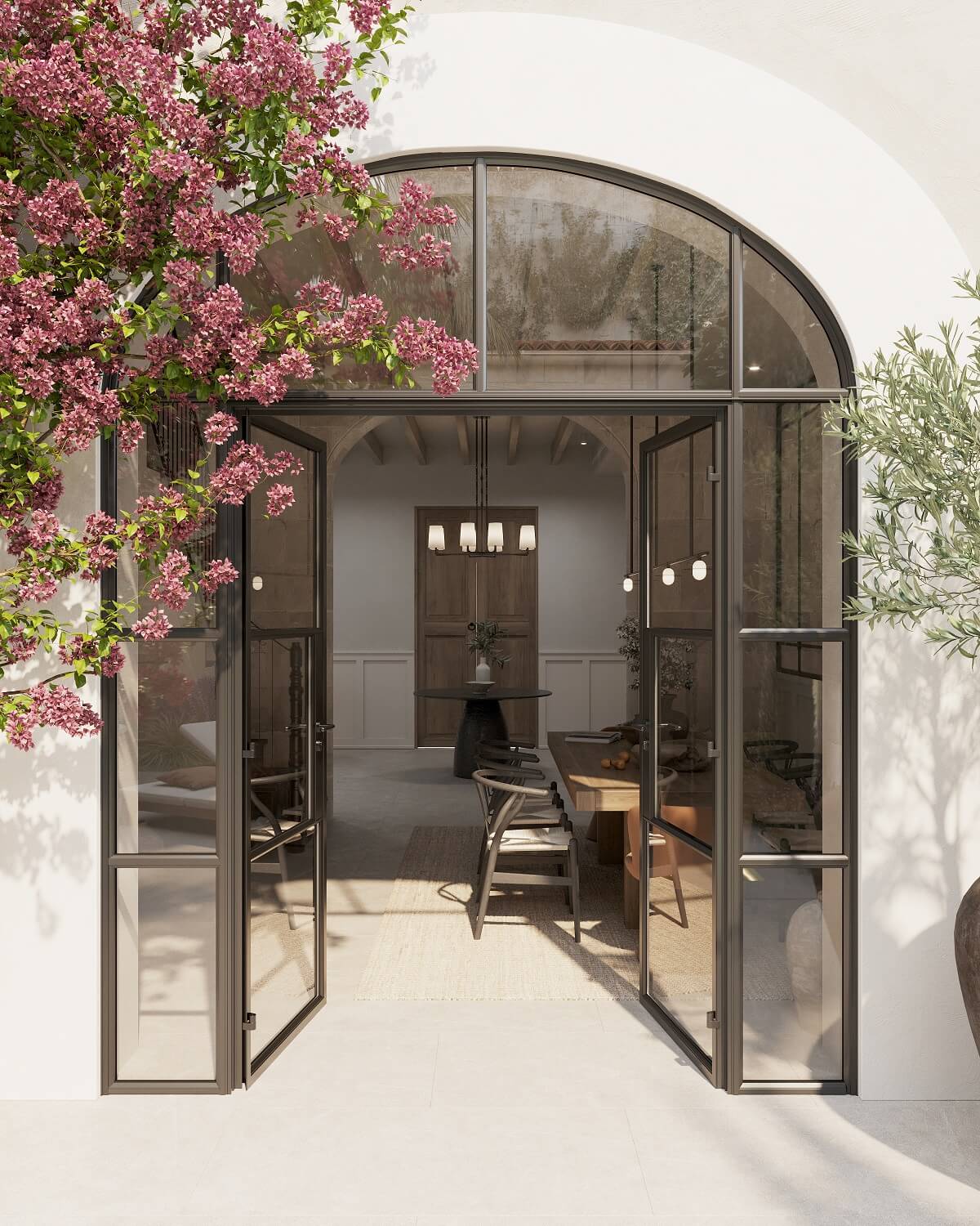 A Renovated Townhouse on Mallorca with a Swimming Pool 20 arched-steel-glass-doors-entry-garden-nordroom