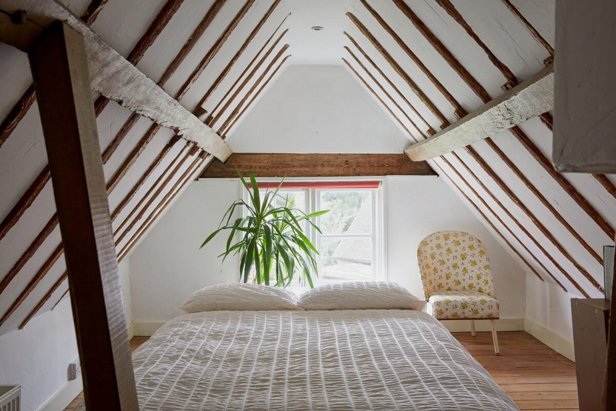 An English Cottage with a Coral Pink Kitchen 12 attic-bedroom-exposed-wooden-beams-nordroom