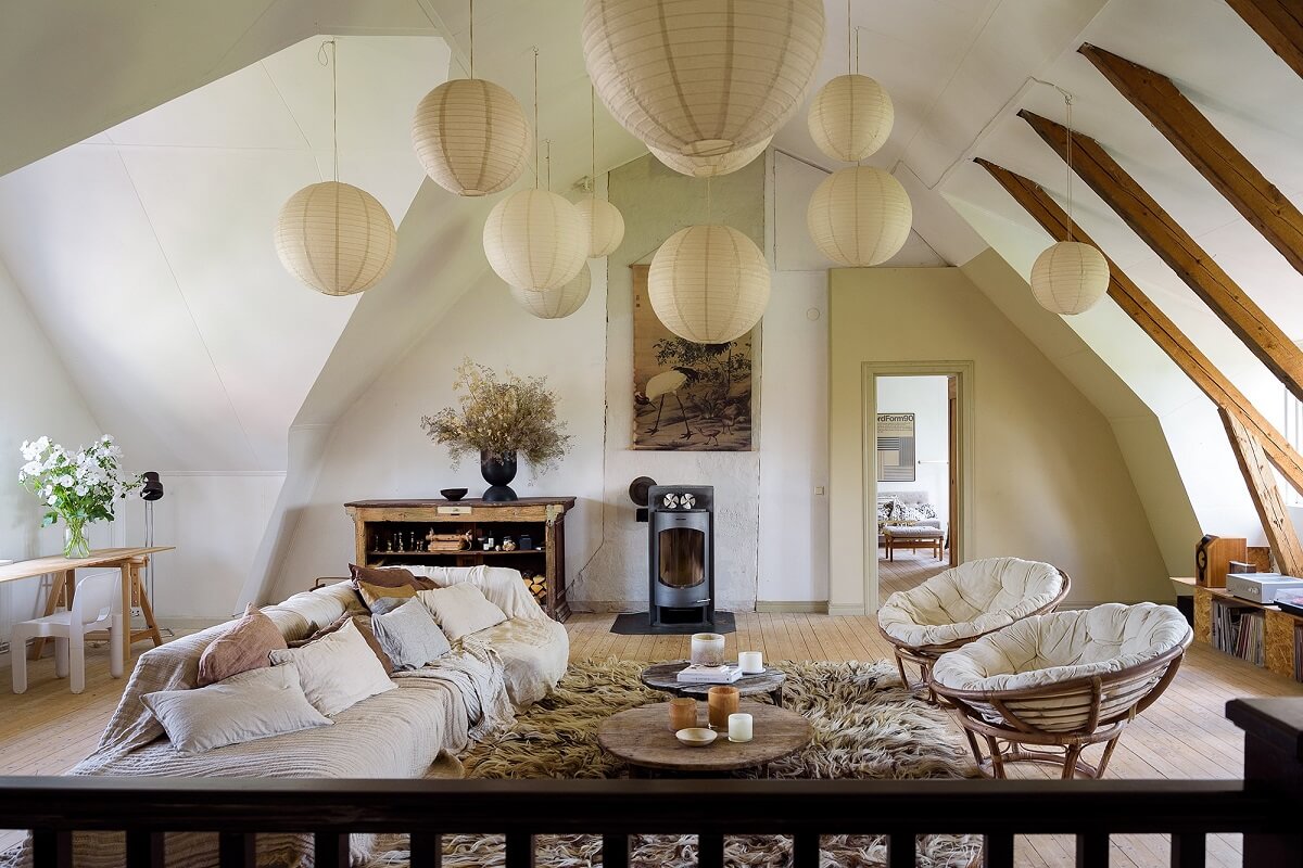 Natural Colors in a Swedish School Conversion 2 attic-living-room-slanted-ceiling-wooden-beams-pendants-nordroom