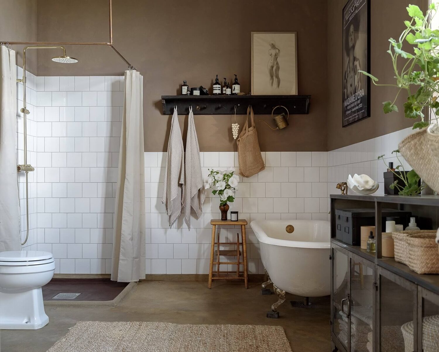 Natural Colors in a Swedish School Conversion 22 bathroom-light-brown-walls-white-tiles-clawfoot-bath-nordroom