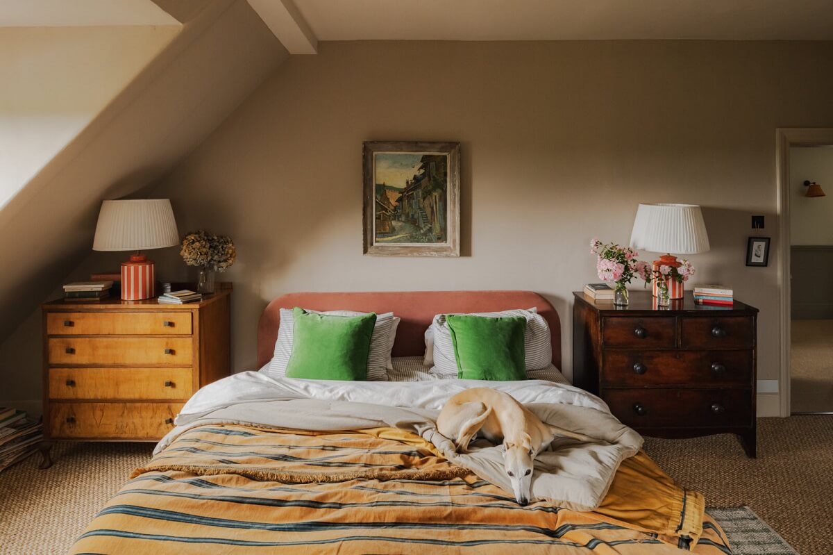 A Colorful Renovated Country House by Clarence & Graves 19 bedroom-gray-walls-slanted-ceiling-pink-headboard-nordroom
