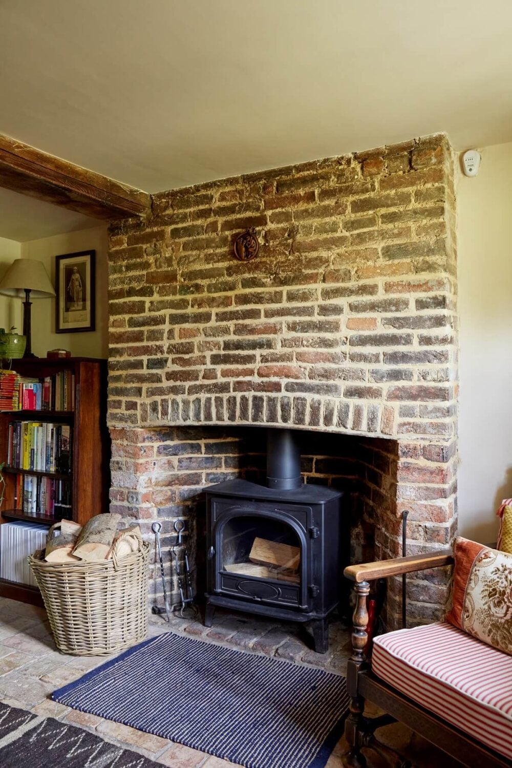 An English Cottage with a Coral Pink Kitchen 4 brick-mantel-woodburning-stove-english-cottage-nordroom