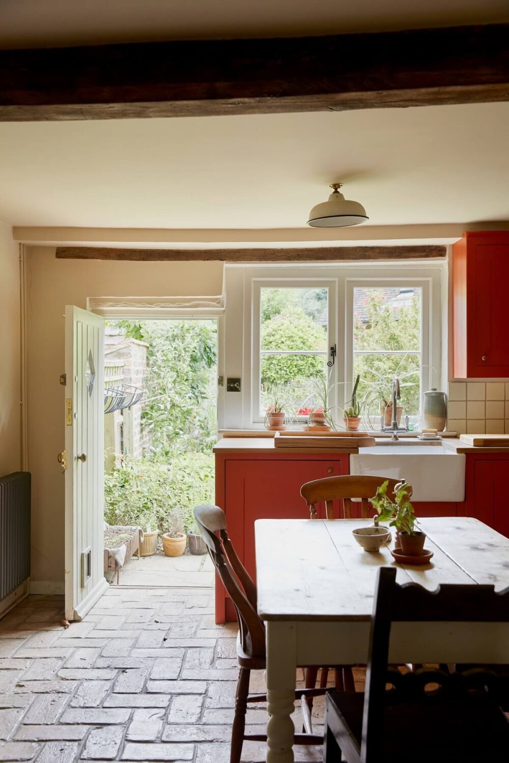 An English Cottage with a Coral Pink Kitchen 9 cottage-kitchen-stone-floor-garden-view-nordroom