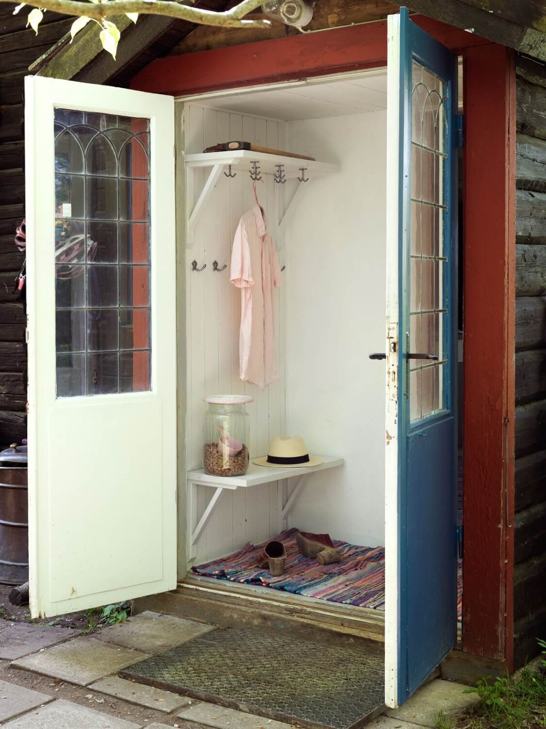 A Rustic Log Cabin With A Green Bathroom 16 double-doors-hallway-log-cabin-sweden-nordroom