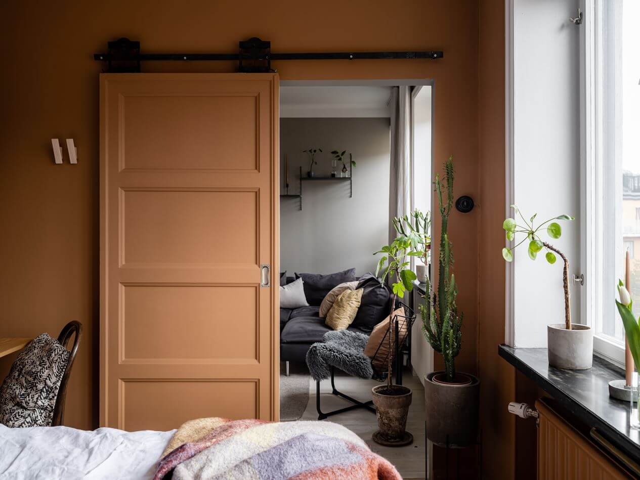 A Gray Nordic Apartment with a Terracotta Bedroom 19 earthy-terracotta-wall-color-bedroom-nordroom