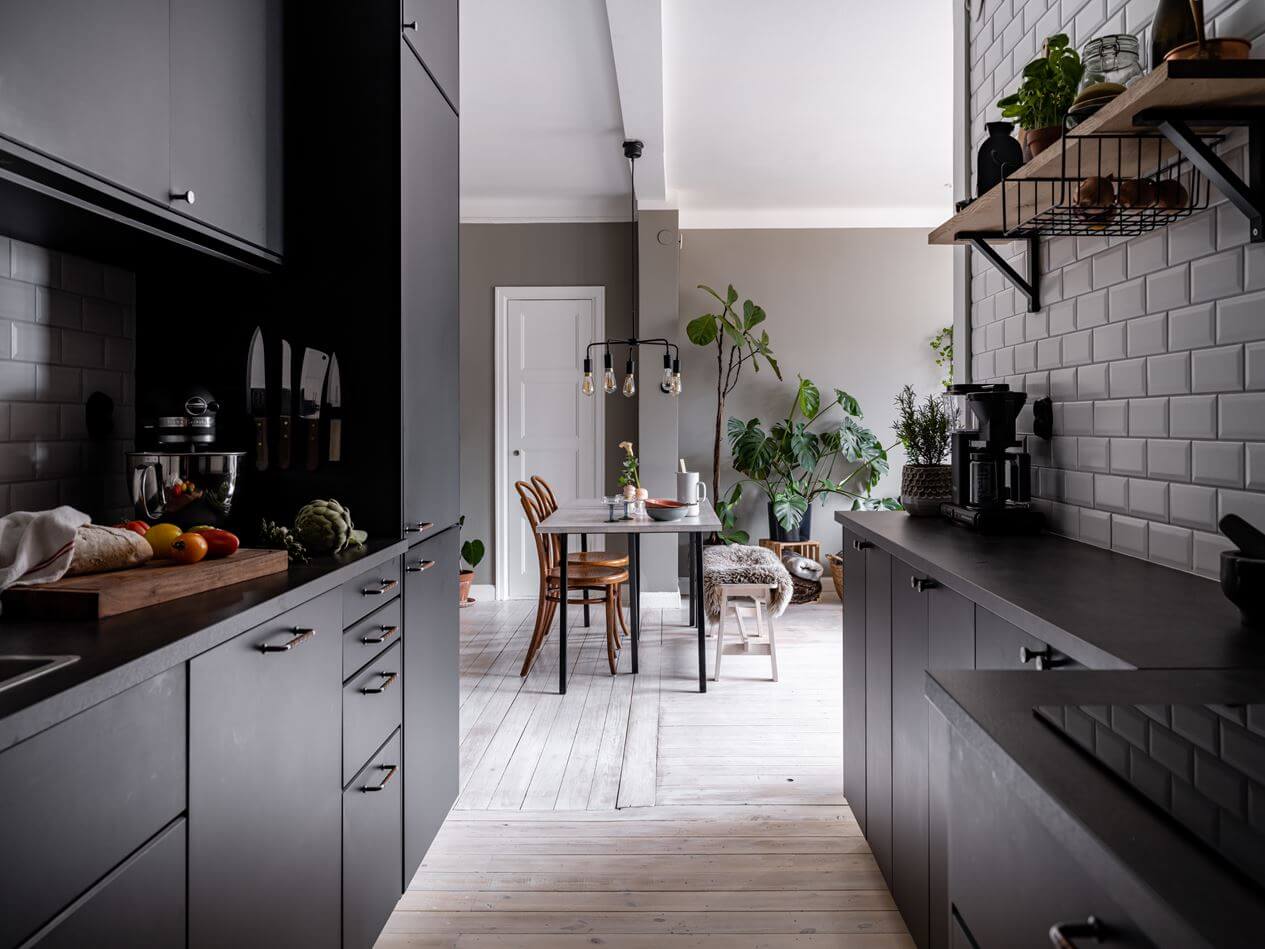 A Gray Nordic Apartment with a Terracotta Bedroom 15 galley-kitchen-black-cabinets-nordroom