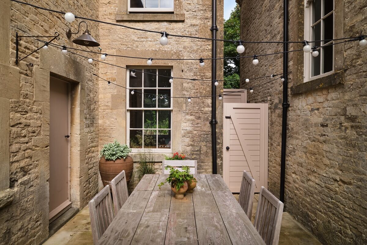 A Beautiful Chapel Conversion in England 23 garden-dining-area-string-lights-nordroom