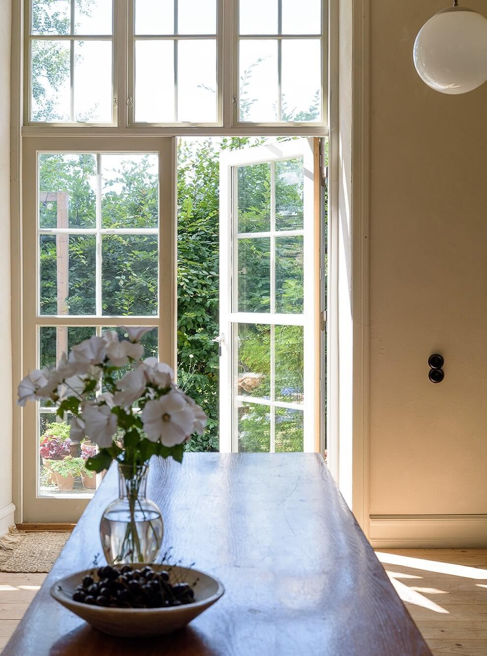 Natural Colors in a Swedish School Conversion 14 garden-doors-kitchen-table-nordroom