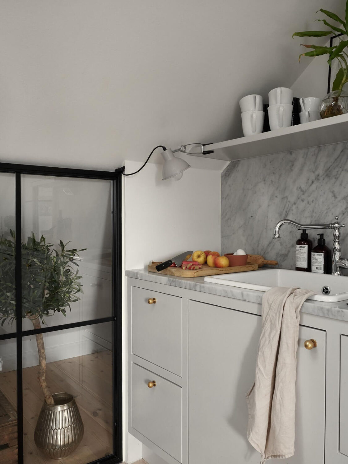 A Small Attic Apartment with Industrial Glass walls 10 industrial-glass-wall-kitchen-light-gray-cabinets-nordroom