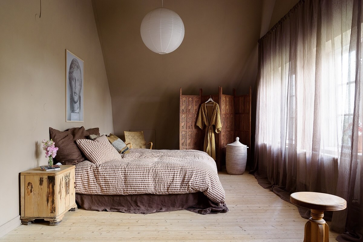Natural Colors in a Swedish School Conversion 21 light-brown-bedroom-slanted-ceiling-nordroom