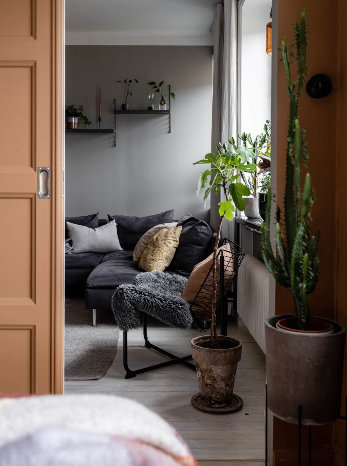 A Gray Nordic Apartment with a Terracotta Bedroom 20 light-brown-sliding-door-living-room-nordroom