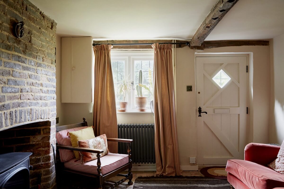 An English Cottage with a Coral Pink Kitchen 2 living-room-brick-mantel-entry-pink-color-accents-nordroom