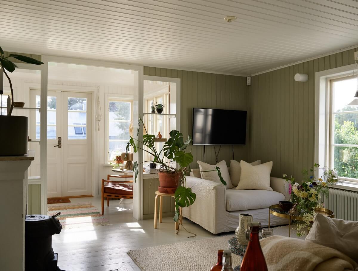 A Small Historic Swedish House with a Modern Extension 14 living-room-green-painted-wooden-walls-nordroom