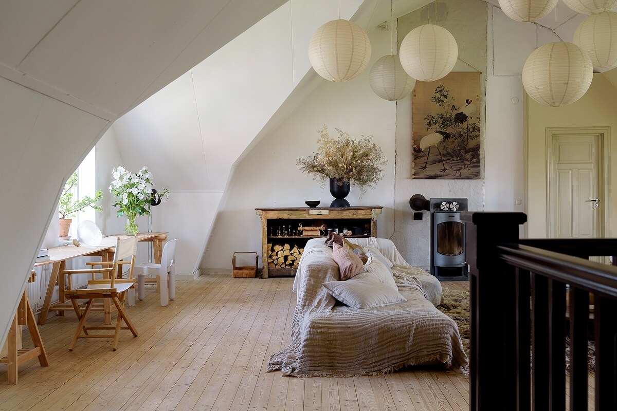 Natural Colors in a Swedish School Conversion 5 living-room-slanted-ceiling-wooden-floor-desk-nordroom
