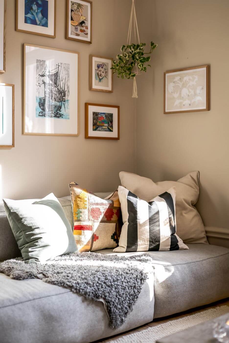 A Custom Headboard in a Light-Filled Swedish Apartment 2 living-room-sofa-hanging-plant-beige-walls-nordroom