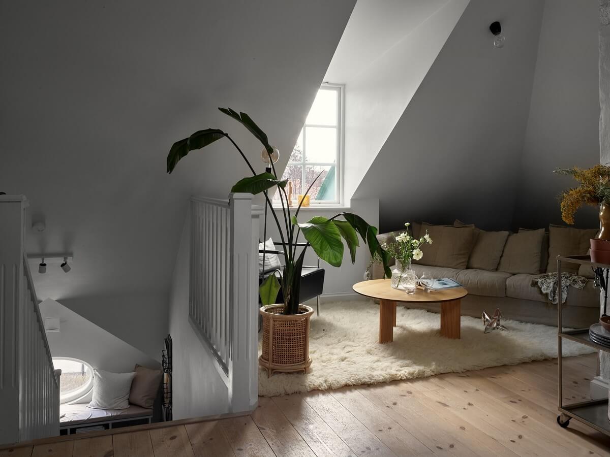 A Small Attic Apartment with Industrial Glass walls 2 living-space-slanted-ceilings