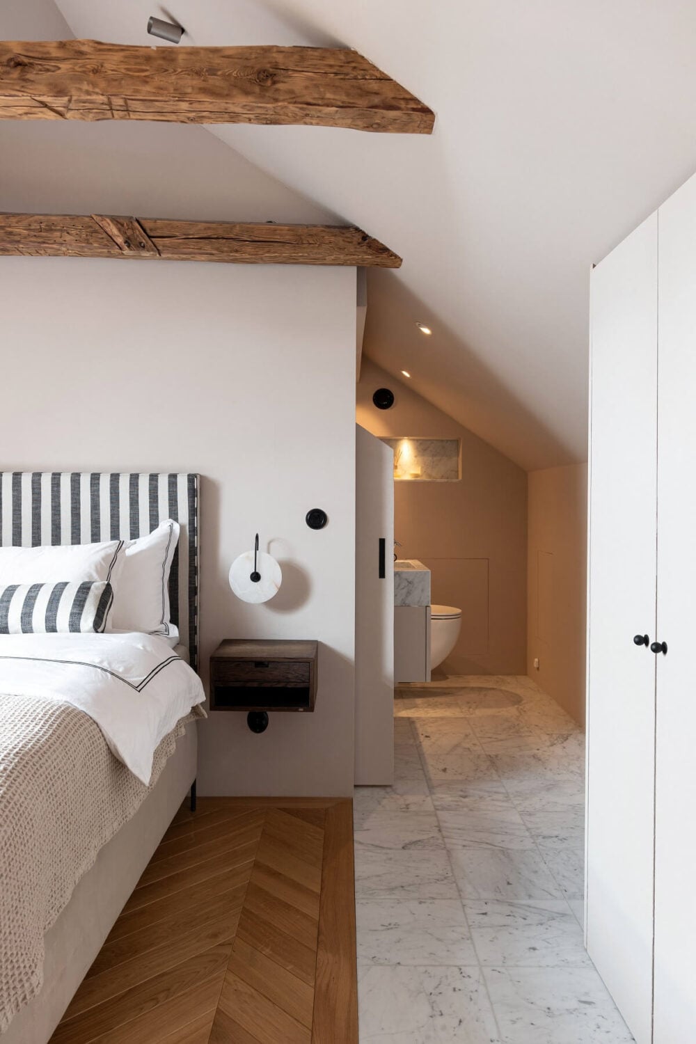 A Luxurious Penthouse Apartment in Stockholm 24 master-bedroom-ensuite-bathroom-striped-headboard-nordroom