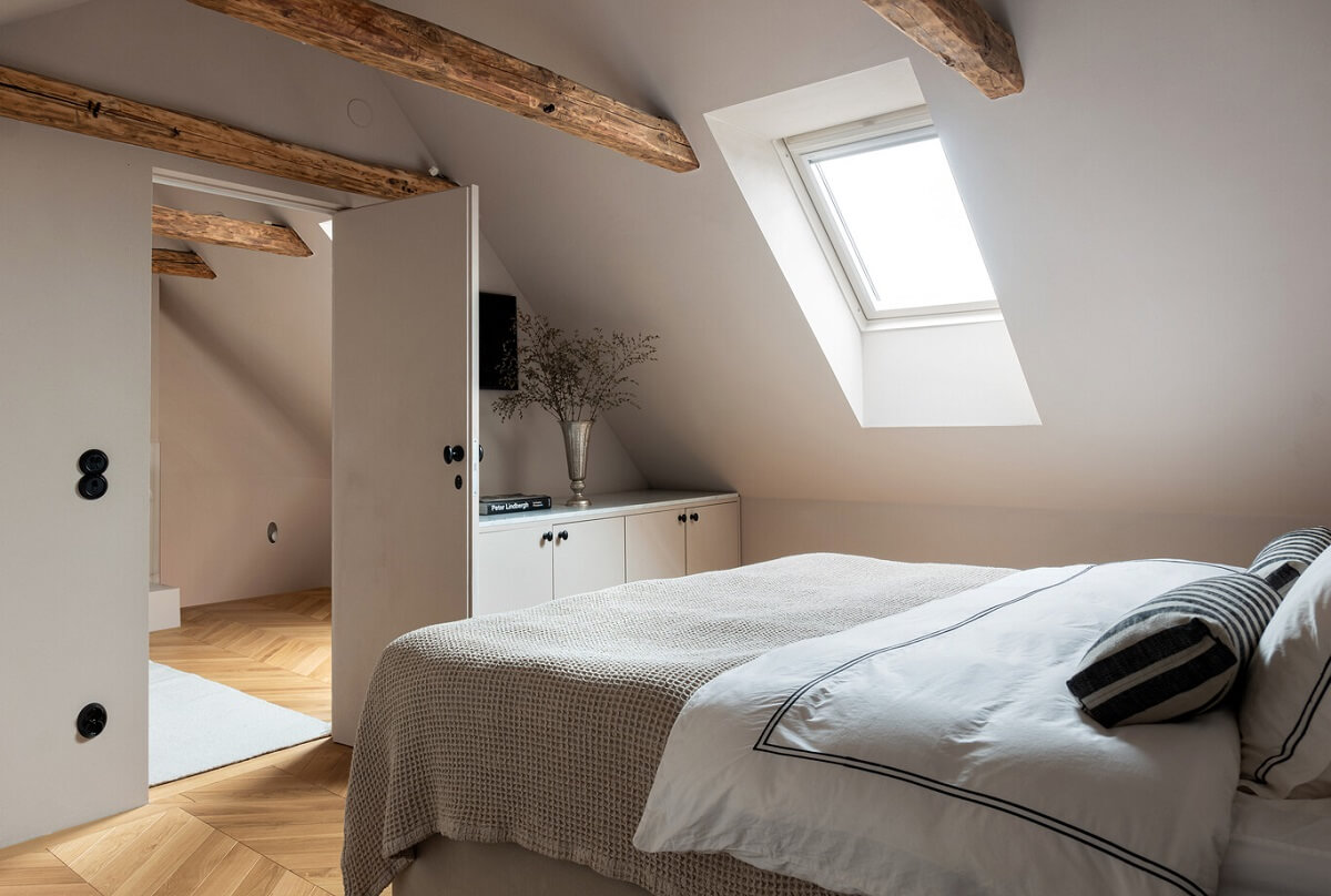 A Luxurious Penthouse Apartment in Stockholm 25 master-bedroom-slanted-ceiling-wooden-beams-nordroom