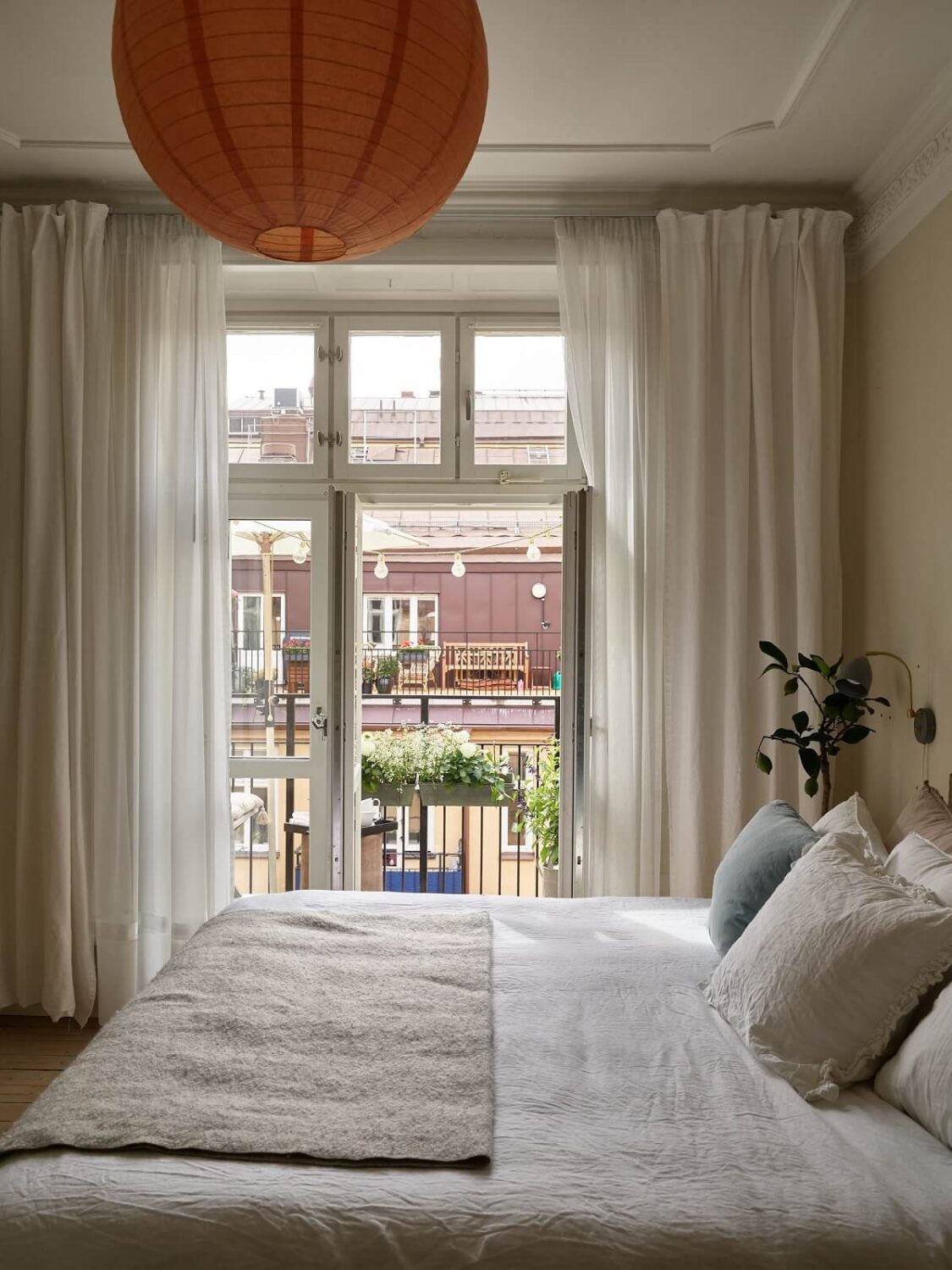 Beige Walls in a Serene Family Apartment in Sweden 18 master-bedroom-with-balcony