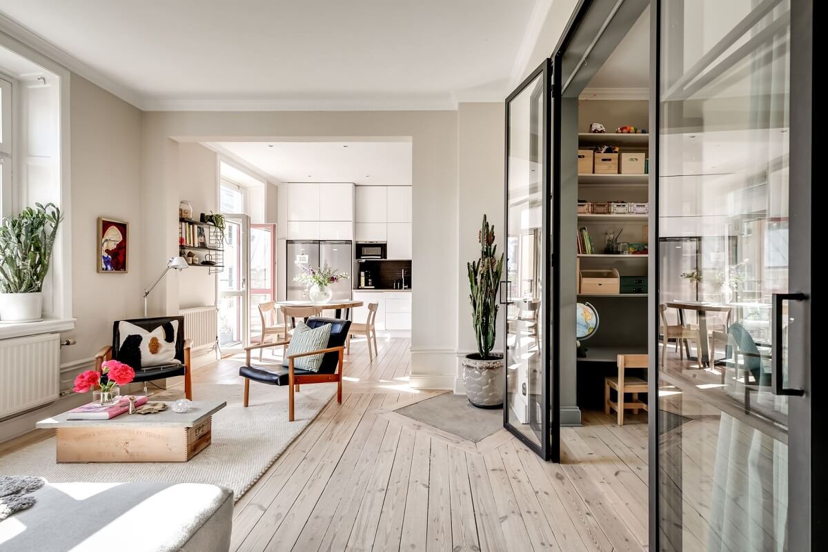 A Custom Headboard in a Light-Filled Swedish Apartment 6 open-plan-living-space-wooden-floor-industrial-glass-doors-nordroom