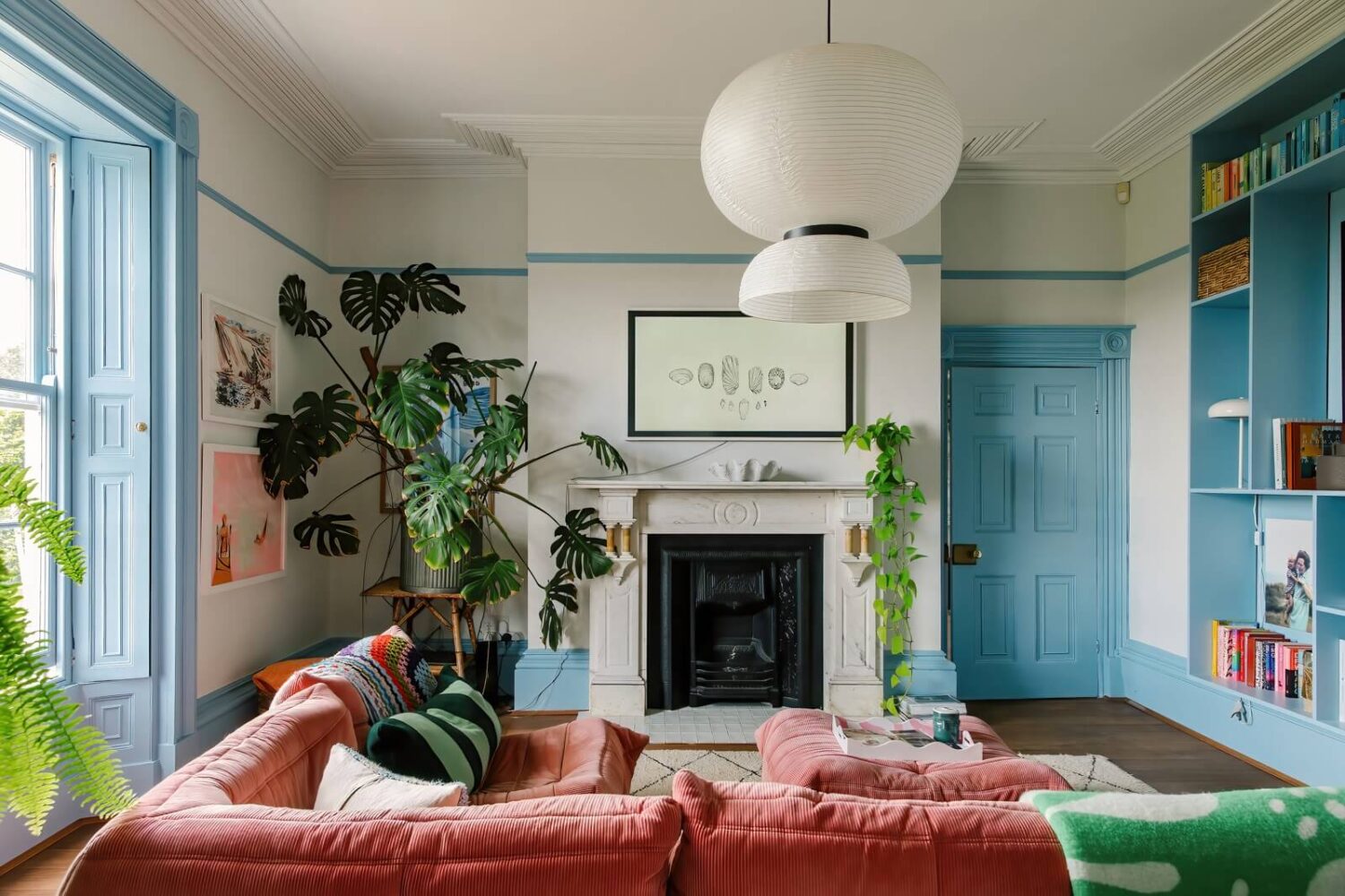 A Georgian House in England with Bold Color Pops 1 pink-l-shaped-couch-light-blue-trimmings-door-nordroom