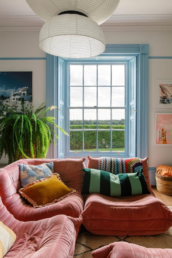 A Georgian House in England with Bold Color Pops 2 pink-togo-sofa-blue-window-frames-nordroom