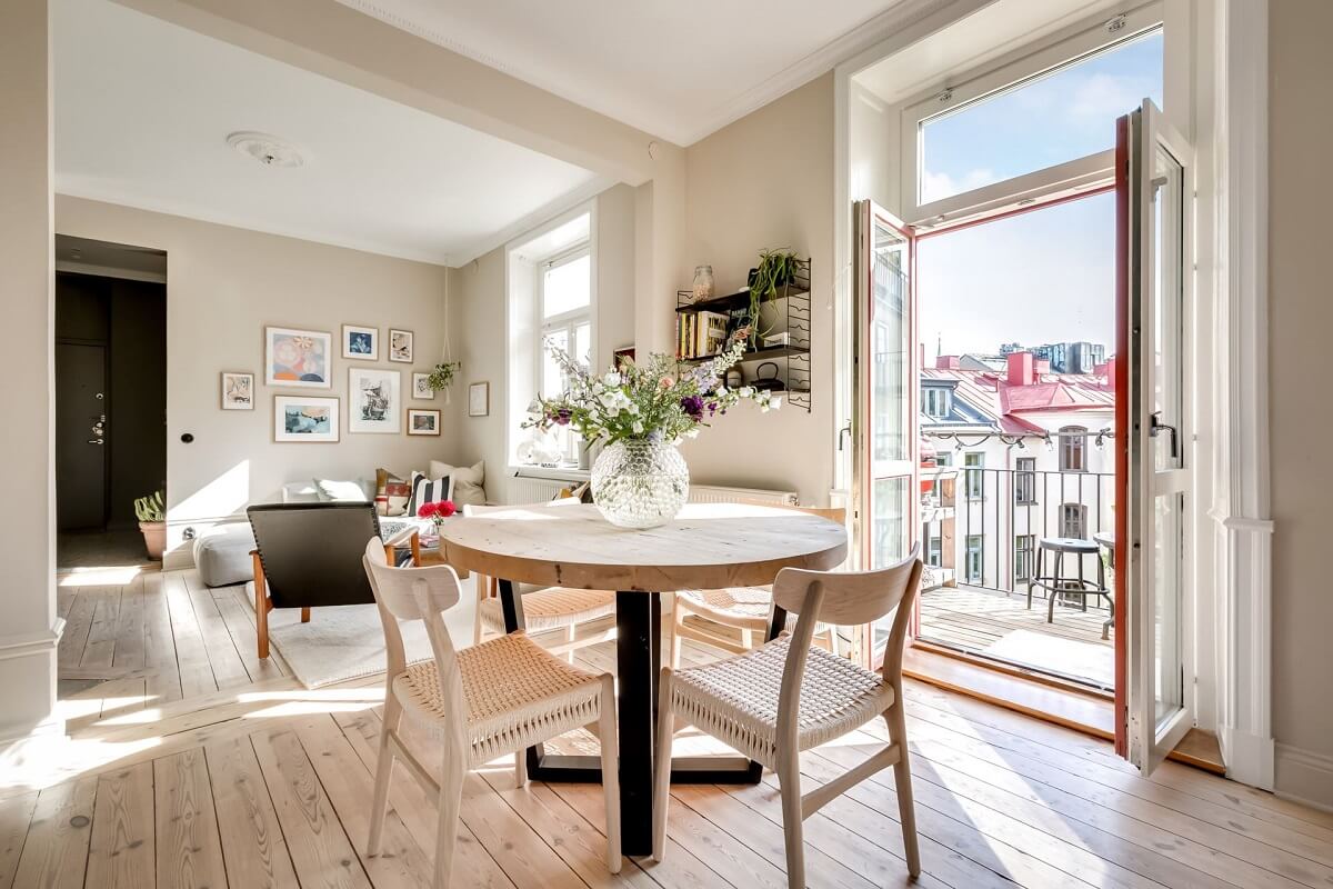 A Custom Headboard in a Light-Filled Swedish Apartment 13 round-dining-table-balcony-open-plan-nordic-apartment-nordroom