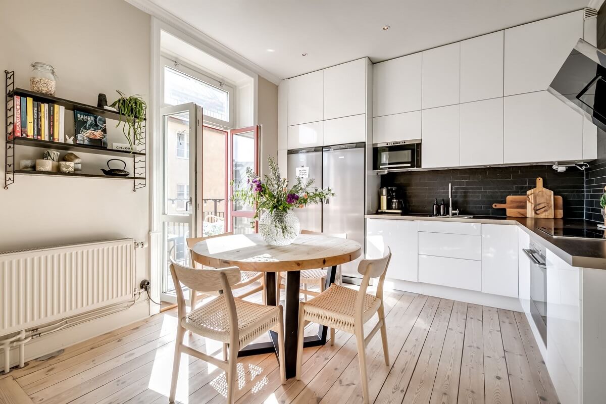 A Custom Headboard in a Light-Filled Swedish Apartment 11 round-dining-table-white-kitchen-black-backsplash-nordroom