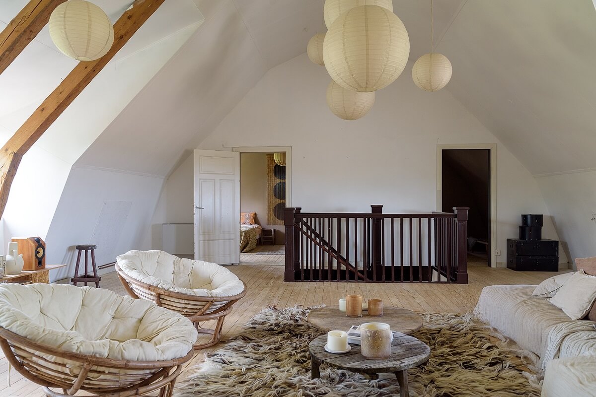 Natural Colors in a Swedish School Conversion 4 serene-living-room-slanted-ceiling-wooden-beams-nordroom