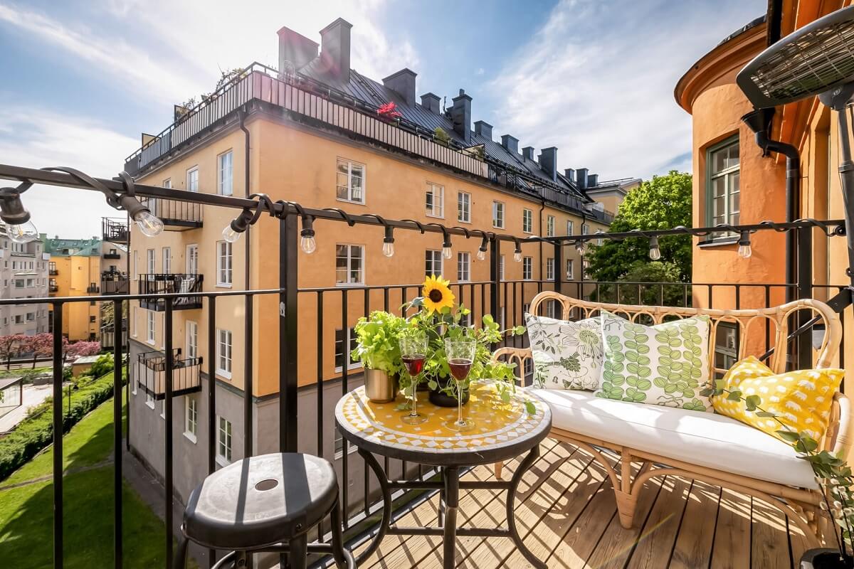 A Custom Headboard in a Light-Filled Swedish Apartment 14 sunny-balcony-swedish-apartment-complex-nordroom