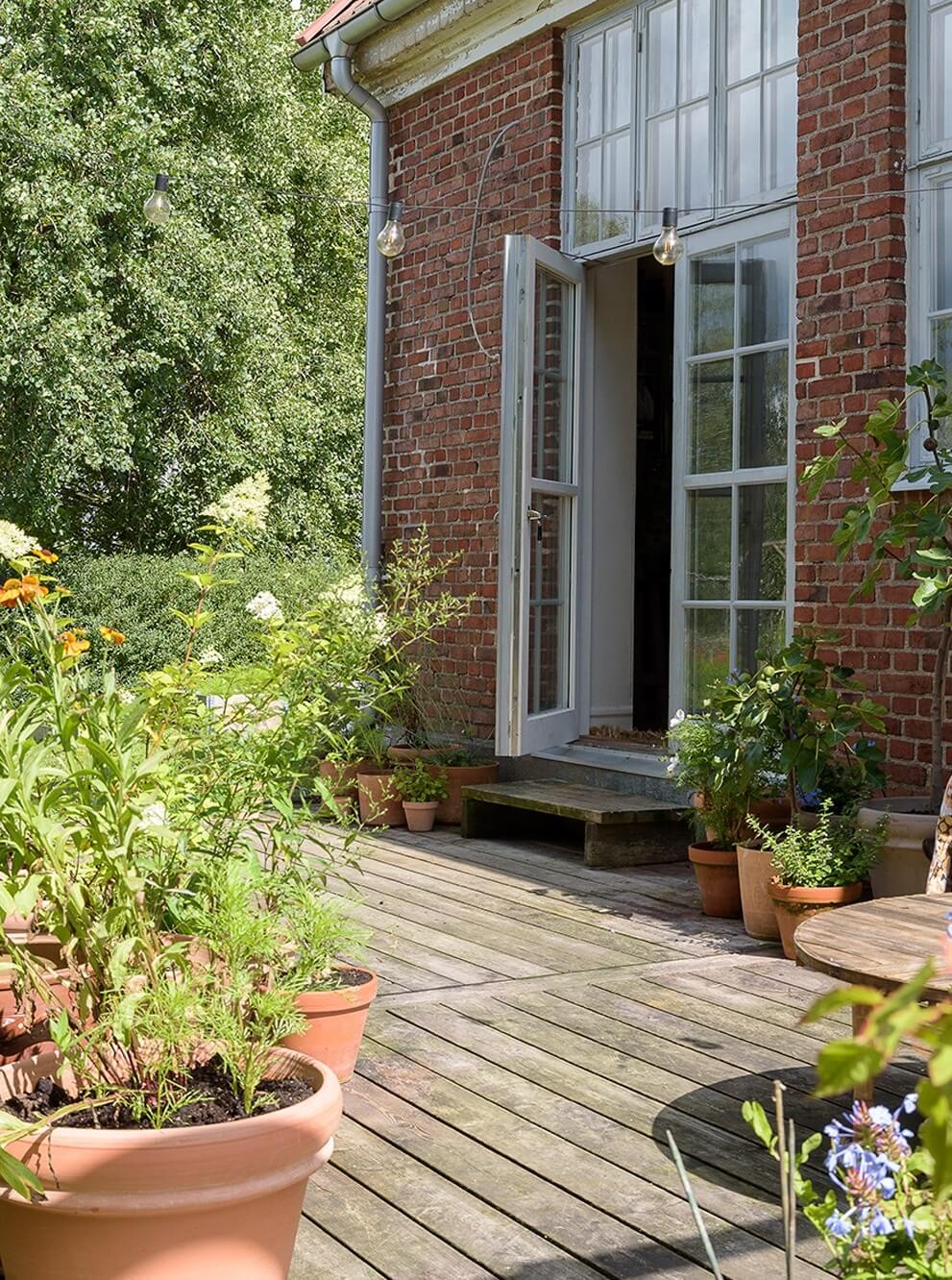 Natural Colors in a Swedish School Conversion 30 wooden-terrace-school-conversion-garden-nordroom