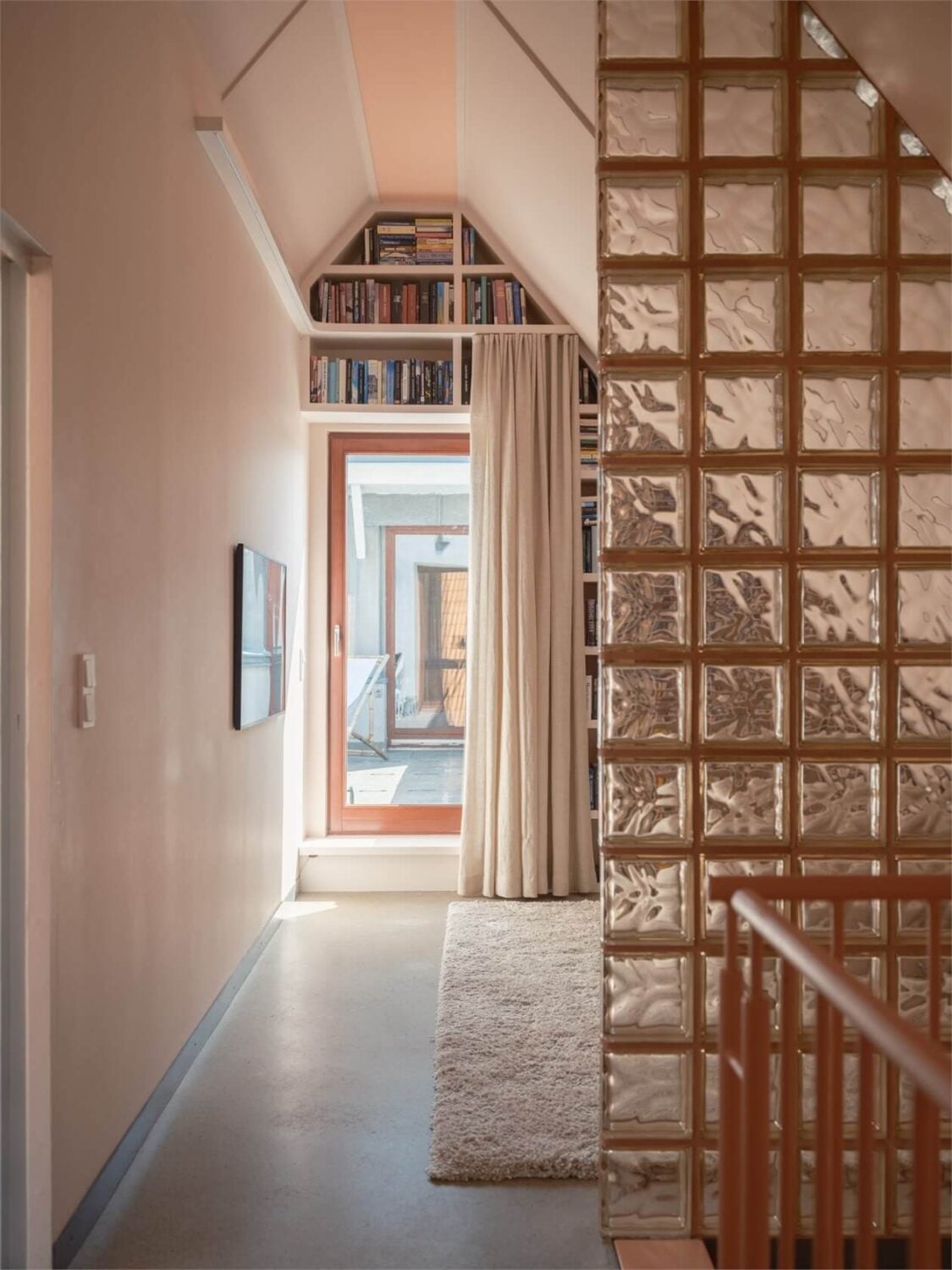 A Colorful Modern Townhouse in Malmö 16 attic-space-slanted-ceiling-bookshelves-nordroom