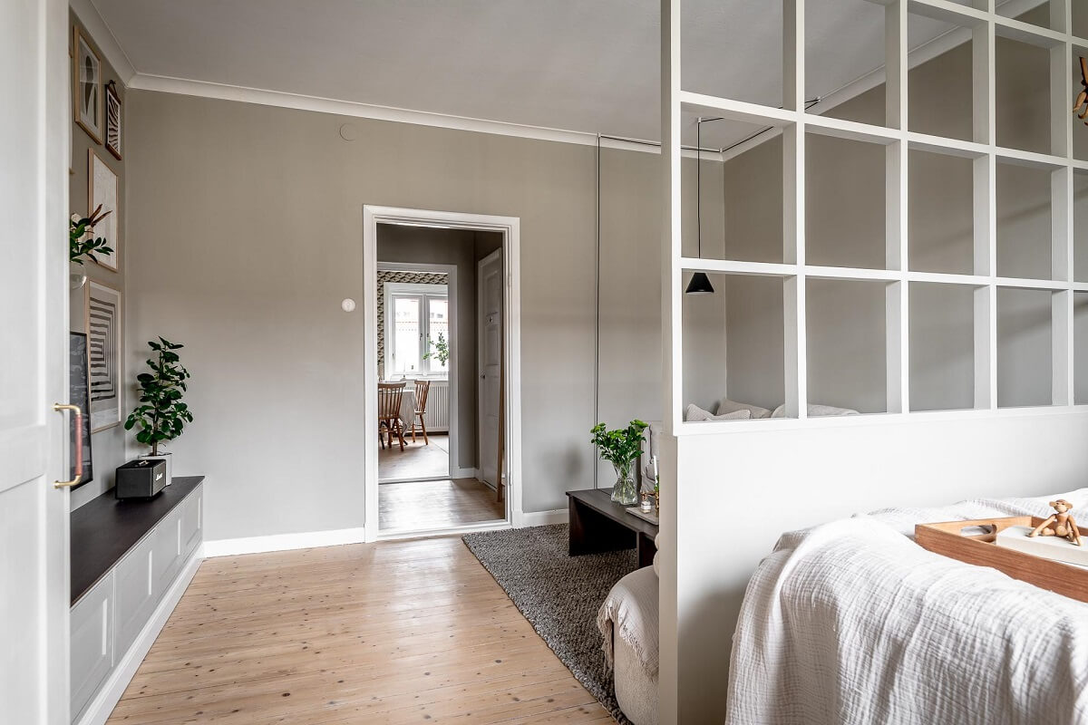A Serene Studio Apartment with a Brown Kitchen 8 bed-niche-half-wall-nordroom