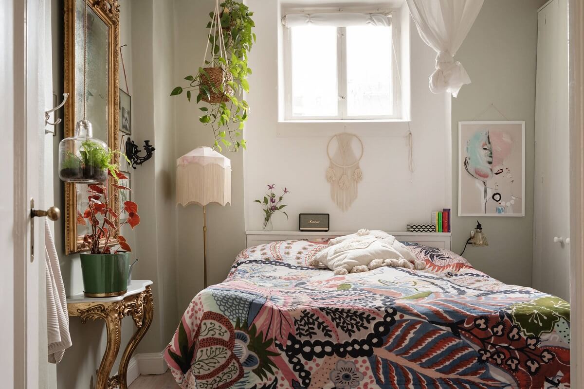 A Lovely Swedish House Revisited 8 bedroom-colorful-bed-spread-hanging-plants-antique-mirror-nordroom