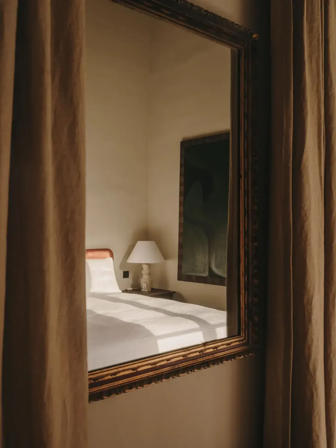 A Historic Townhouse on Majorca with a Striped Pool 24 bedroom-detail-antique-mirror