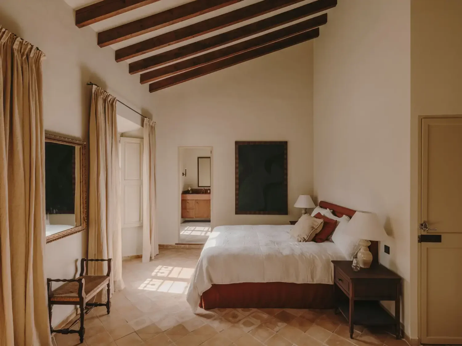 A Historic Townhouse on Majorca with a Striped Pool 26 bedroom-slanted-ceiling-with-wooden-beams-nordroom