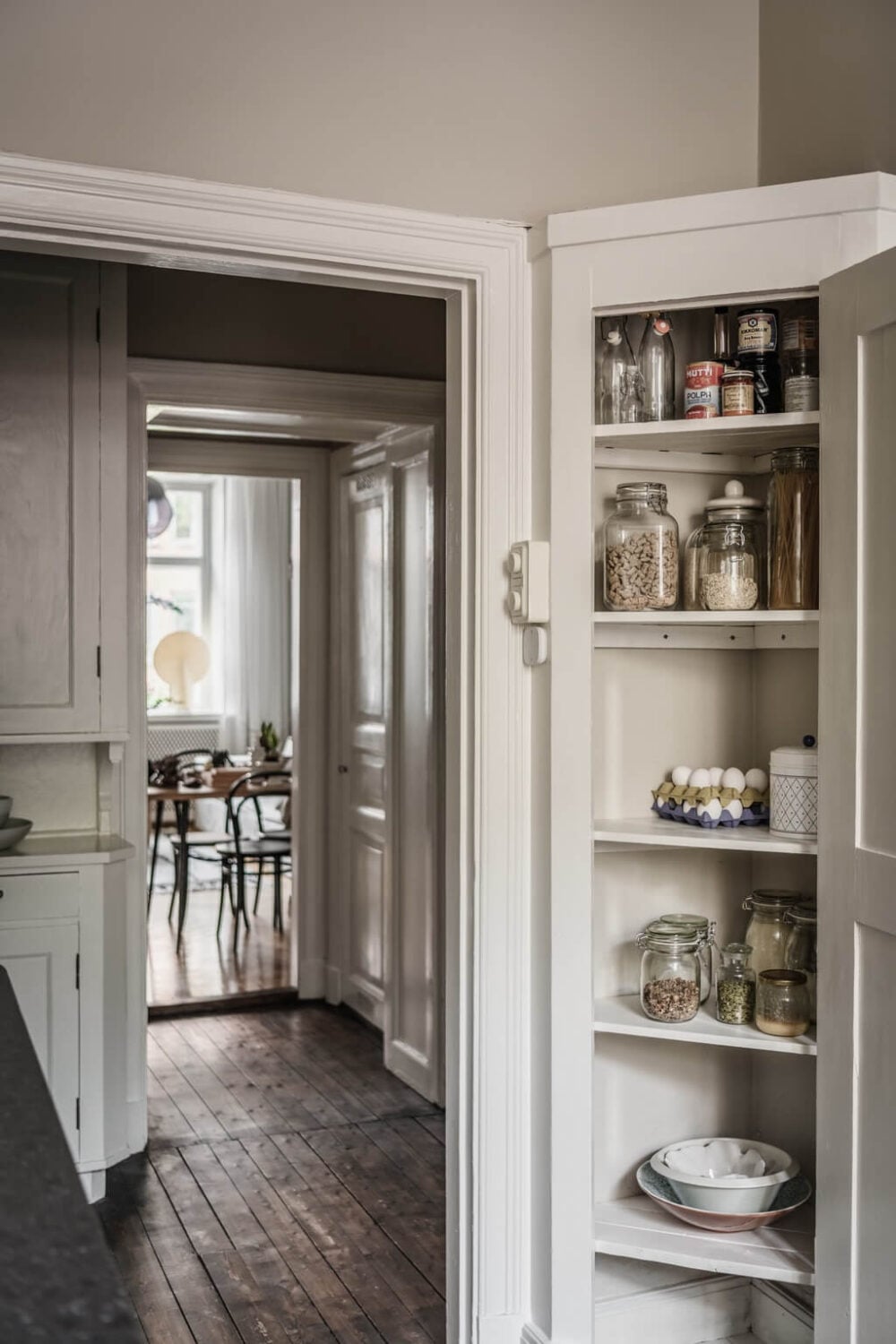 A Dark Gray Painted Ceiling in a Scandi Apartment 21 built-in-corner-cabinet-kitchen-nordroom