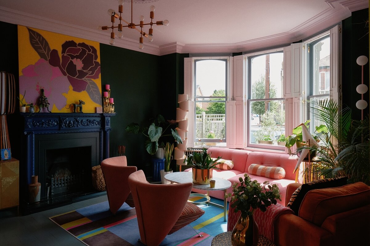 A Fun Colorful Family House in England 1 colorful-living-room-green-walls-pink-sofa-blue-fireplace-nordroom
