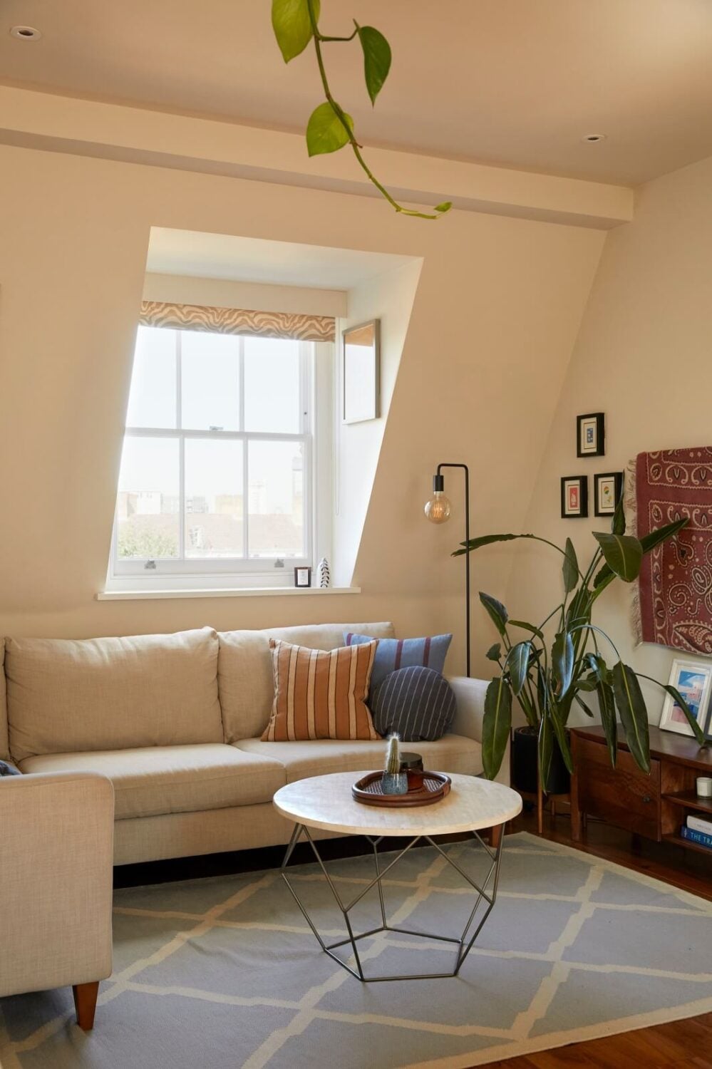 A Light Attic Apartment in London 1 corner-sofa-living-room-slanted-ceiling-light-blue-rug-nordroom