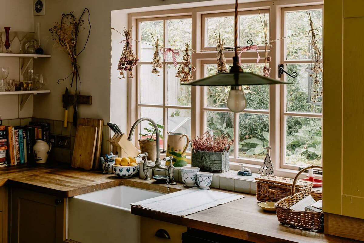 A Charming English Cottage with Color Accents 10 cottage-kitchen-yellow-cabinets-garden-view-nordroom