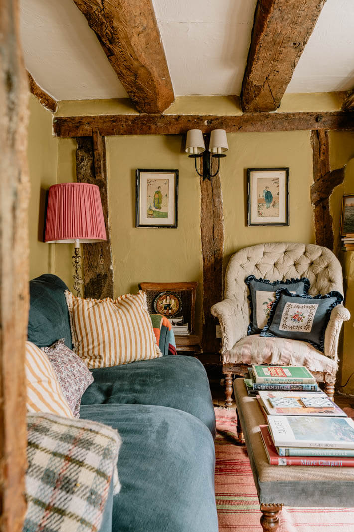 A Charming English Cottage with Color Accents 3 cozy-cottage-living-room-exposed-wooden-beams-nordroom