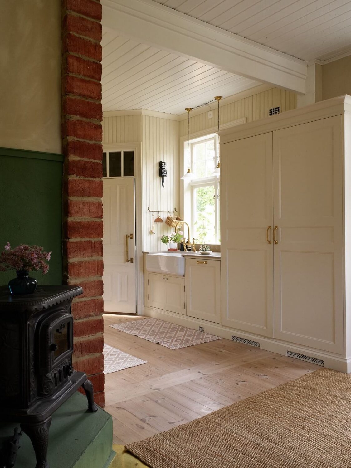 A Beautiful Swedish Country House with a Large Garden 3 cream-kitchen-wood-burning-stove-wooden-floor-nordroom