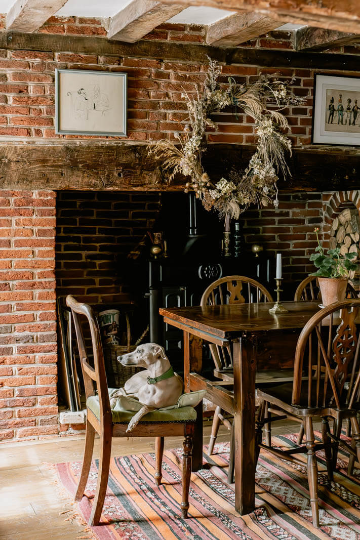 A Charming English Cottage with Color Accents 7 dining-room-exposed-brick-walls-fireplace-nordroom