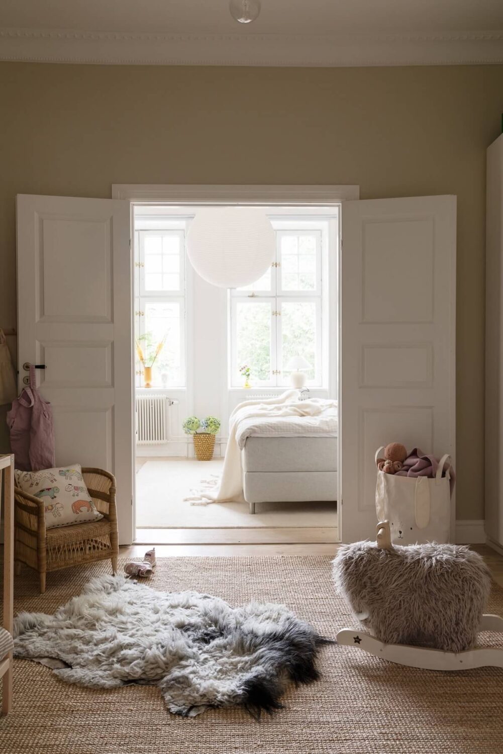 A Light Swedish Apartment with an Industrial Glass Wall 18 double-doors-leading-to-bedroom-nordroom