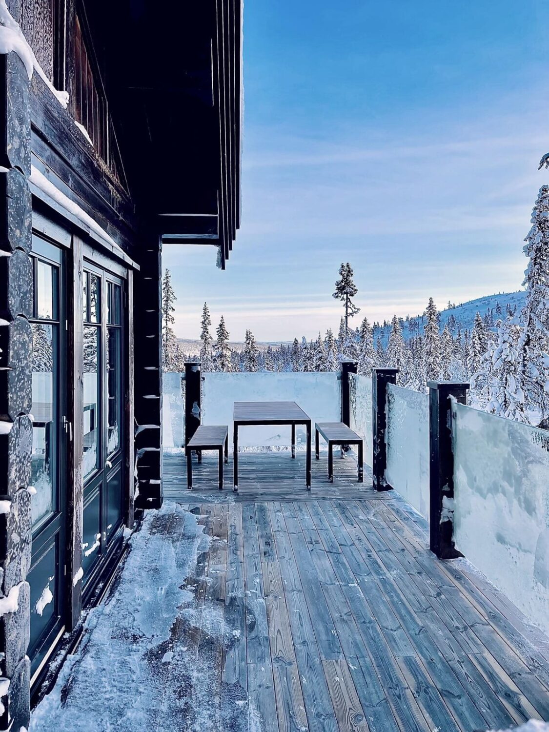 A Modern Rustic Log House in Sweden 17 exterior-wooden-terrace-snow-nordroom
