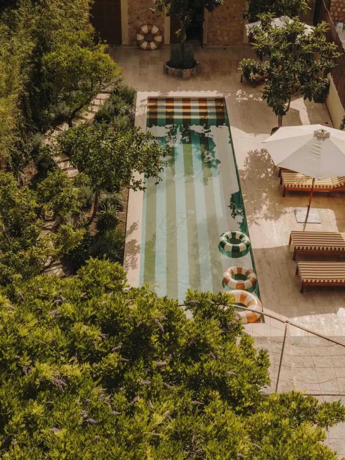 The 2026 Home Decor and Color Trends, According to Pinterest 12 garden-from-above-with-yellow-white-striped-swimming-pool-nordroom