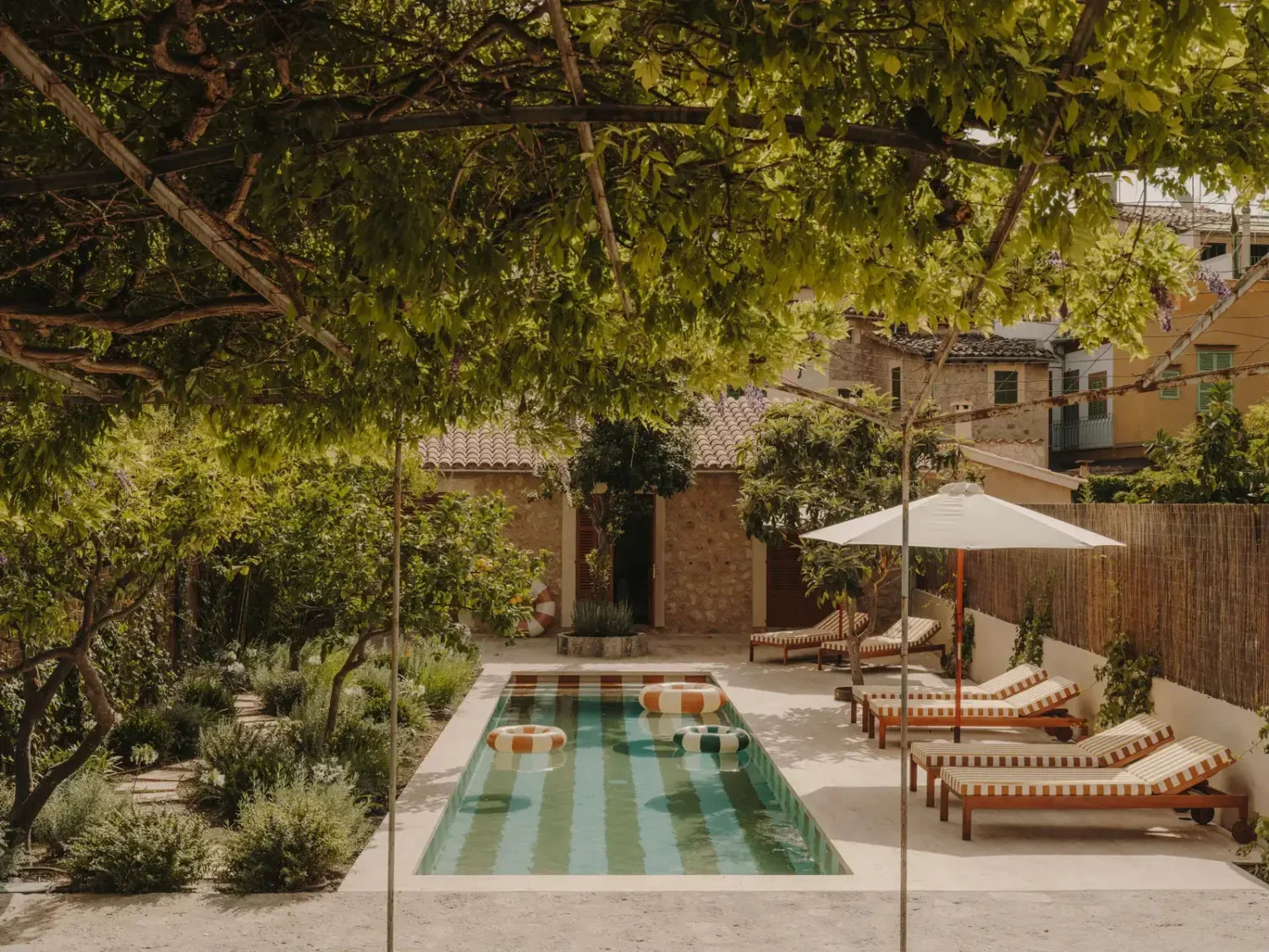 A Historic Townhouse on Majorca with a Striped Pool 30 garden-with-striped-tiles-swimming-pool-nordroom