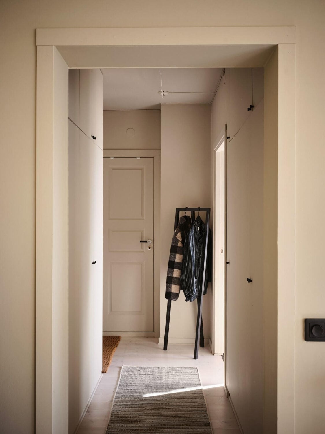 A Serene Beige Apartment with Two Balconies 17 gray-hallway-clothing-rack-nordroom
